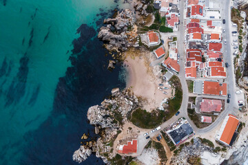 Aerial view of Praia dos Barcos, a small inlet with beach along the coastline in Baleal, a small town on island in Leiria, Portugal.