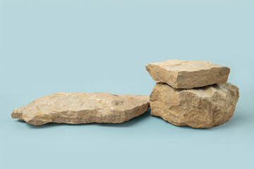 Stone podium for cosmetic product presentation. Abstract minimal backdrop. Three rock form. Light Blue Studio Background. Scene show. Showcase display case. 3D Front View. Trendy neutral color. Space