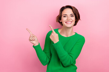 Photo of lovely cute girl wear green clothes arms demonstrates empty space advise nice offer empty...