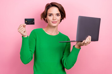 Photo of pretty good mood lady wear green pullover paying bills ecard modern device isolated pink color background