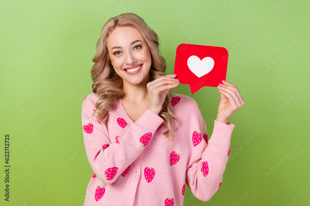 Poster Photo of young blonde wavy hair girl wear pink strawberry print shirt hold postcard blogger subscribe linkedin isolated on green background