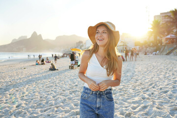 Digital Detox. Smiling young woman on Ipanema beach at sunset, Rio de Janeiro, Brazil. Positive mental health beneficts concept.