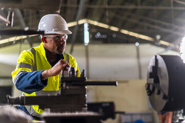 African worker Engineer working with cnc lathe machine for quality of product in factory with confident