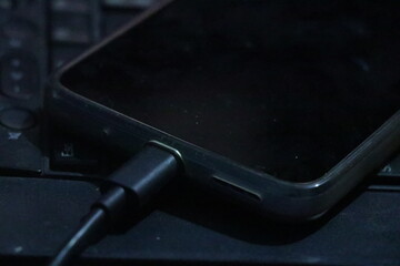 mobile phone with cable on white background