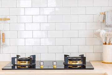 minimalist kitchen. Selective focus on gas stove appliance and countertop surface with blurred kitchenware