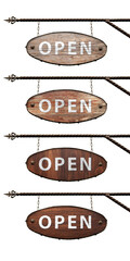 Collection of oval wooden signs. An old oval OPEN sign hangs from a wrought iron structure....