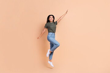 Full size photo of jumping overjoyed japanese girl have fun wear khaki t-shirt military style brand...