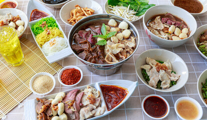 Thai boat noodles with Thai spices and ingredient on background.