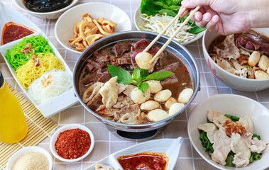 Thai boat noodles with Thai spices and ingredient on background.