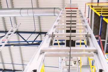Aluminum one-sided ladders indoors close-up.