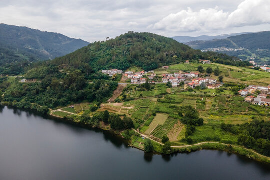 Aerial view of a small village along the Minho river in Val de Pereira, Ourense, Spain.