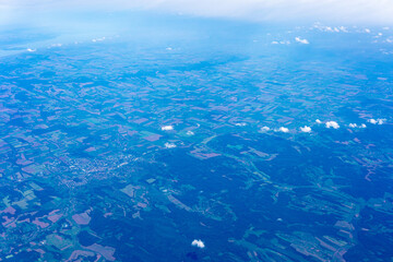 View to a land and clouds from airplane