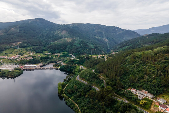 Aerial view of a road driving along the coast of Minho river in Val de Pereira, Ourense, Spain.