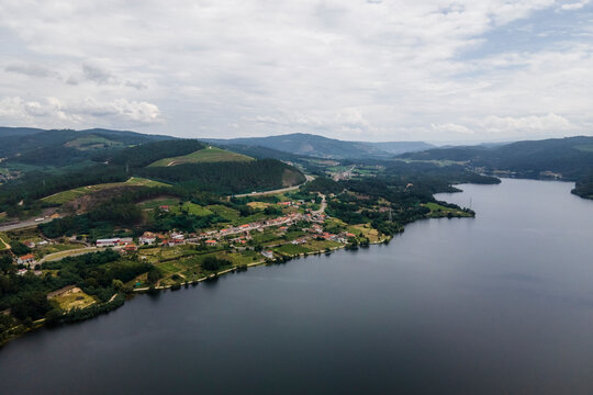 Aerial view of a small village along the Minho river in Val de Pereira, Ourense, Spain.