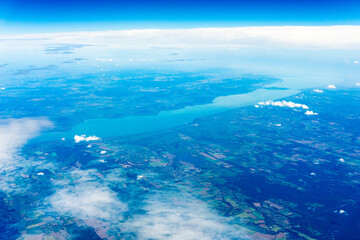 Fototapeta na wymiar View to a land and clouds from airplane