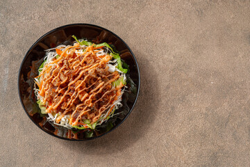 Crispy beef fillet pieces with mayonnaise plating on a black plate