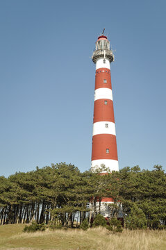 red and white striped lighthouse on the coast of Ameland, netherlands