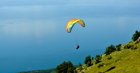 Tandem Paraglider flying over the Lake Ohrid in soutwest of macedonia