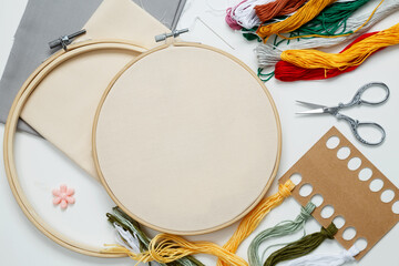 Embroidery set fot stitching. Beige cotton cloth in embroidery hoop on white background with...