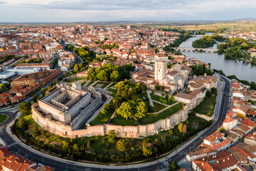 Aerial view of Zamora old town with fortified walls, view of the main cathedral and the castle at sunset, Spain.