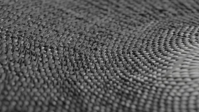Grey wicker texture. Abstract intertwined natural pattern. Macro. Rotation