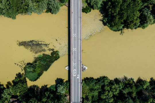 Aerial view of a car driving on the bridge crossing the Pisuerga river in Simancas, Spain.