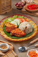 Nasi Jeruk Ayam Geprek is Indonesian Food crispy fried chicken with hot and spicy sambal bawang. Served with rice