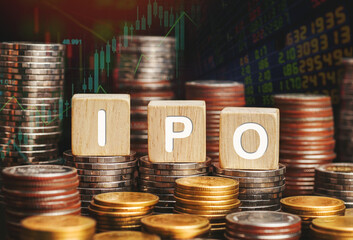 Initial Public Offering, IPO concept on cubes and Blurred stock market trading graphs and...