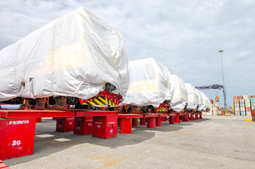 Transport of Oversize Heavy Machinery cargo truck Loading a new locomotive port area