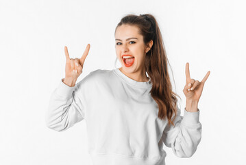 Awesome party rocks. Portrait carefree good-looking stylish girl having fun dancing. Emotional brunette female makes rock n roll gesture, having fun, posing against white studio background