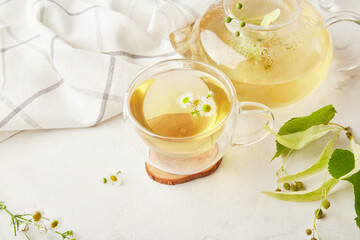 Healthy natural organic linden and chamomile tea blossoms. Summer table setting, natural beverage, benefits and properties concept