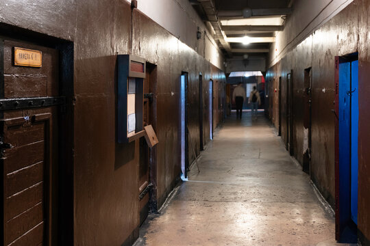Karosta Military Prison Museum at the former Russian Imperial and Soviet Naval Base in Liepāja, Latvia. A corridor with metal cell doors, focus on the left door