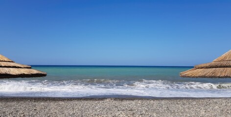 Shot of the sandy shore against a bright summers sky