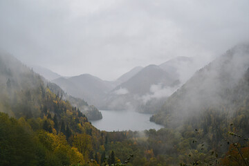 panoramic view of the mountain valley with fog and mountain lake