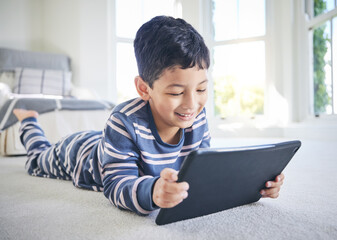 Young boy, tablet and games or cartoon streaming online with internet, e learning and relax on...
