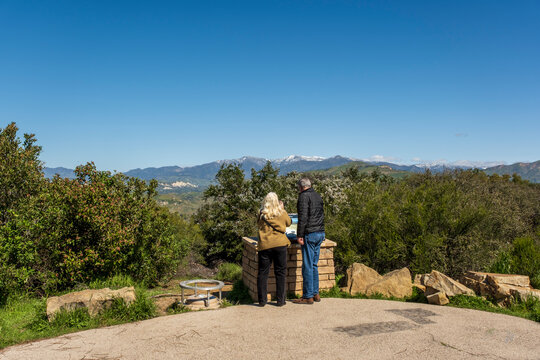 Tourists looking at the landscape at Lake Cachuma and the mountains in California, USA