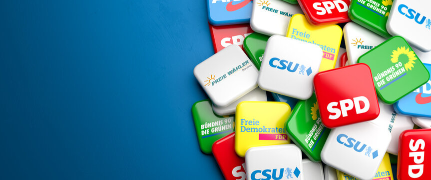 Logos of the main political parties (CSU, Freie W&auml;hler, Die Gr&uuml;nen, SPD, FDP, AfD) running for the Bavarian state election (Landtagswahl Bayern) on a heap on a table. Copy space.