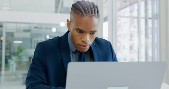 Computer, working and businessman in the office doing research online for a corporate legal project. Technology, professional and young African male lawyer planning a case on a pc in modern workplace