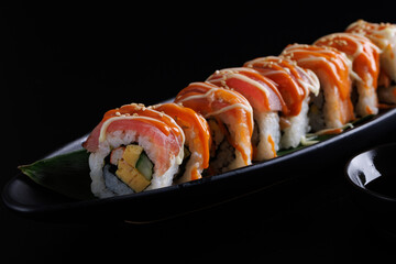 Salmon Sushi roll Japanese food isolated in black background