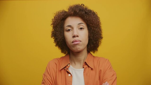 Woman Nodding Head in Yes Gesture on Yellow Background