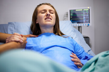 Pregnant woman, hospital and delivery with push, holding hands and support in bed, baby and pain....