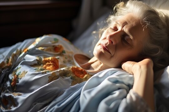 Close up of senior woman lying on her bed and resting.