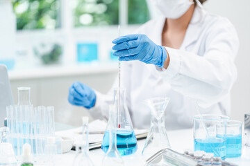 Fototapeta premium medicine research in chemical laboratory, chemist scientist working with liquid experiment test analysis by using scientific tube beaker glassware, chemistry science pharmaceutical medical lab concept