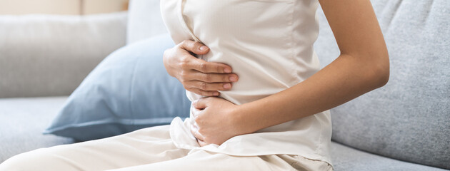 Flatulence ulcer, asian young woman, girl hands in belly, stomach pain from food poisoning,...