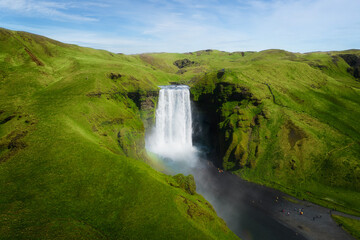 Fototapeta premium Aerial top view of Skogafoss waterfall in summer season. Famous nature landscape background