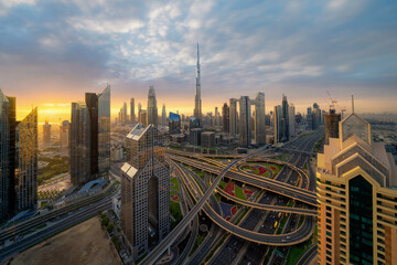 Fototapeta na wymiar Aerial view of Dubai Downtown skyline, highway roads or street in United Arab Emirates or UAE. Financial district and business area in smart urban city. Skyscraper and high-rise buildings at sunset.
