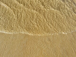 Fototapeta na wymiar texture of waves and sand