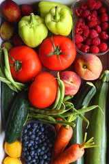 Wooden crate full of healthy colorful seasonal fruit and vegetable. Top view.