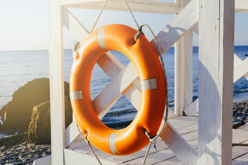 Orange life buoy on the background of the sea.