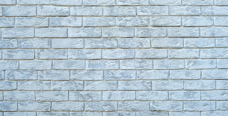 Wall made of white decorative bricks. Background, texture. Wide format, banner.